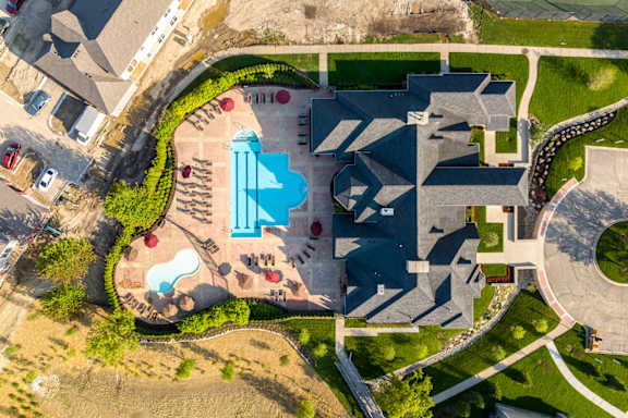 an aerial view of an urban cityscape with a pool of water