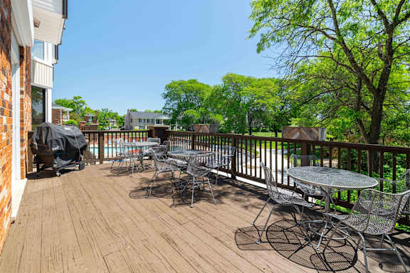 A wooden deck with a table and chairs.