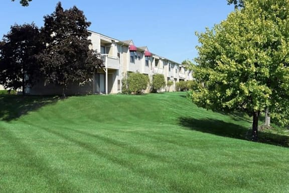a green lawn in front of a building