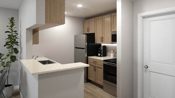 A kitchen with a black fridge and wooden cabinets.