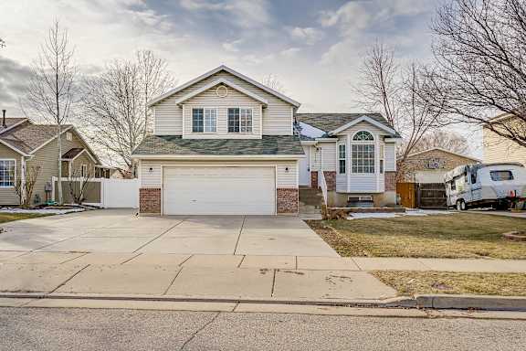 A house with a white garage door is in the foreground.