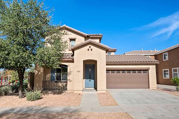 A house with a blue door and a garage door.