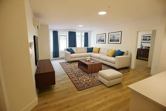 A living room with a white couch and a coffee table.