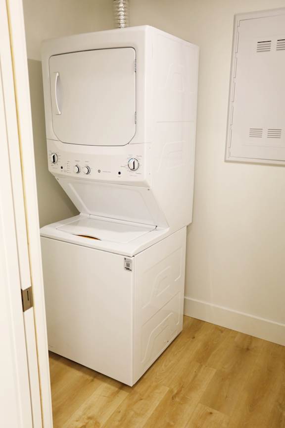 A white dryer is sitting in a room.