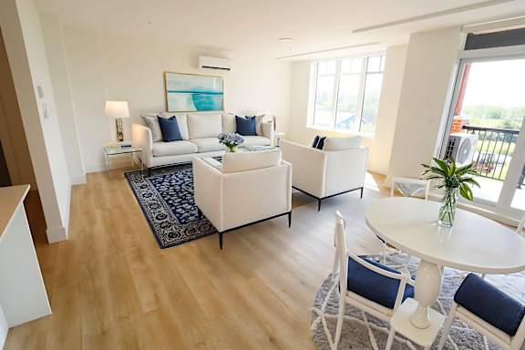 A living room with a white couch and a white coffee table.
