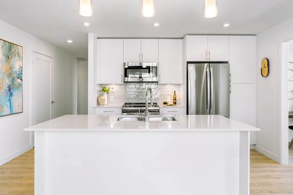 A modern kitchen with a large island in the center.