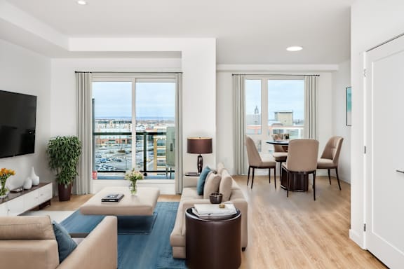 A living room with a large window overlooking a cityscape.