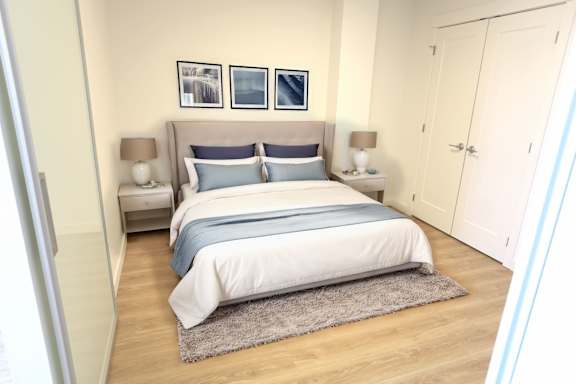 A bedroom with a large bed and a grey headboard.