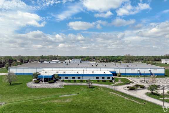 A large industrial building with a blue and white exterior.