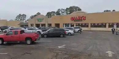 a parking lot full of cars in front of a grocery store