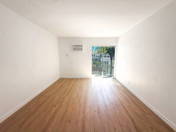 Floor Plan  A room with wooden floors and white walls.