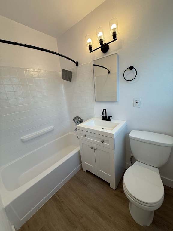A white bathroom with a toilet, sink, and bathtub.