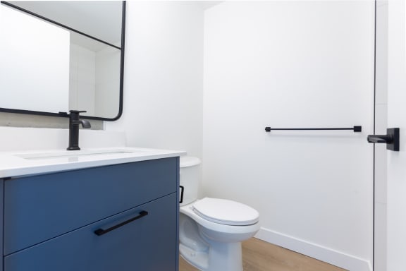 a bathroom with a toilet and a sink and a mirror