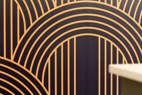 a black and gold wallpaper with a gold spiral design