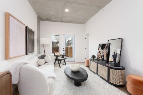 a living room with a couch and a chair and a tv