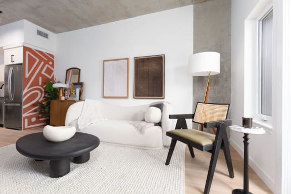 a living room with a couch and a chair and a table