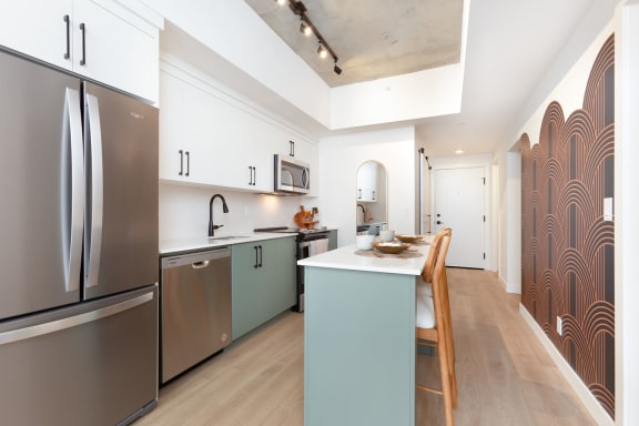 a kitchen with stainless steel appliances and a counter top