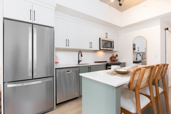a kitchen with stainless steel appliances and a white counter top