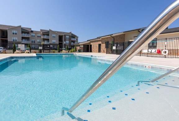 A swimming pool with a metal railing.