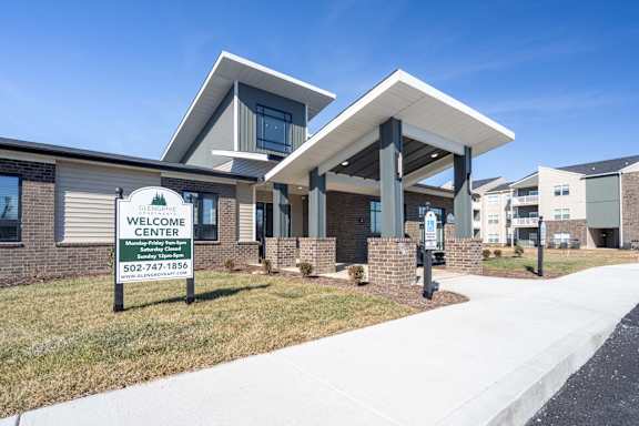 A building with a sign that says "Welcome Center" in front of it.