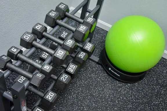 Rack of dumbbells next to a green ball