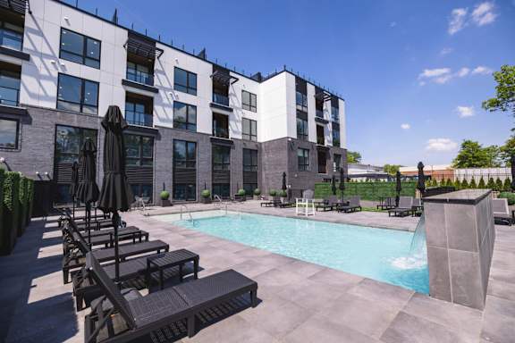 a swimming pool in front of a building at The Franklin at Westfield, Westfield