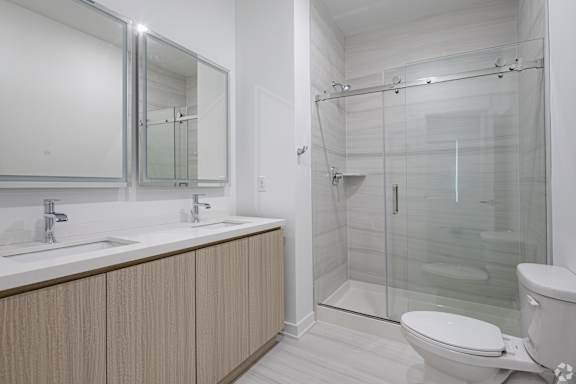 A white bathroom with a walk in shower.