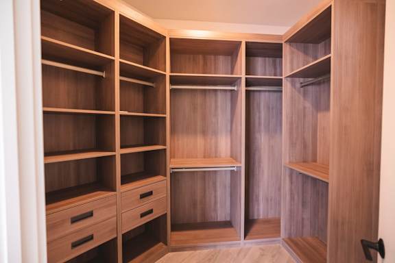 a walk in closet with wooden shelves and drawers at The Franklin at Westfield, Westfield, 07090