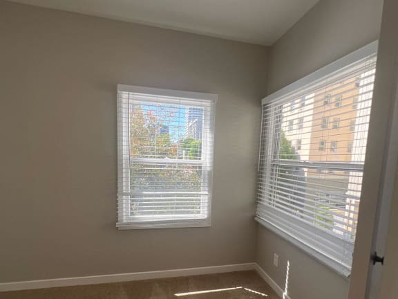 a living room with two windows and a door