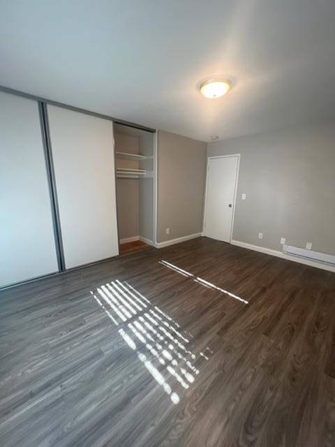 a room with white walls and a wooden floor