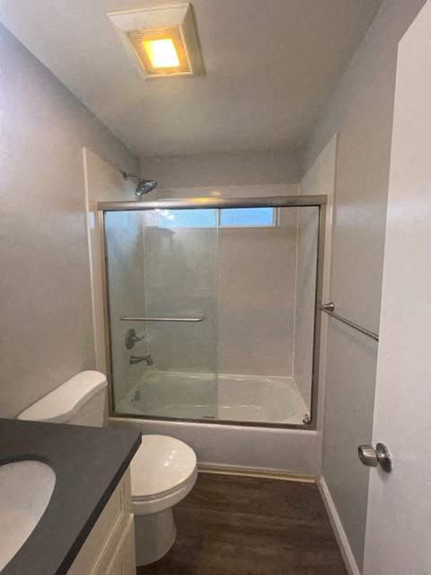 a bathroom with a shower and a toilet and a sink