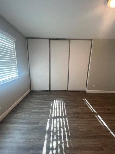 an empty room with wooden floors and white walls