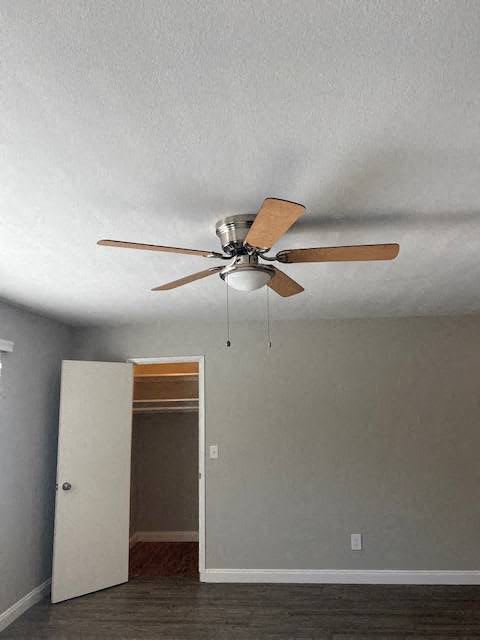 a ceiling fan in a room with an open door