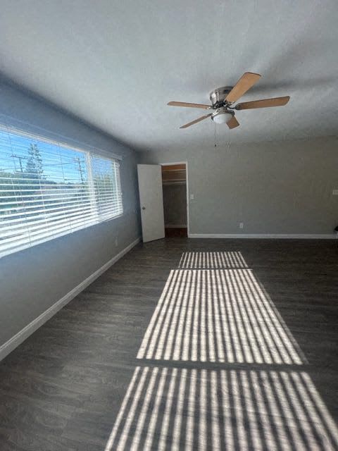 a living room with a ceiling fan and a window