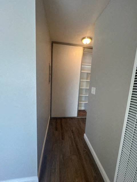 a hallway with a closet and a light on the ceiling