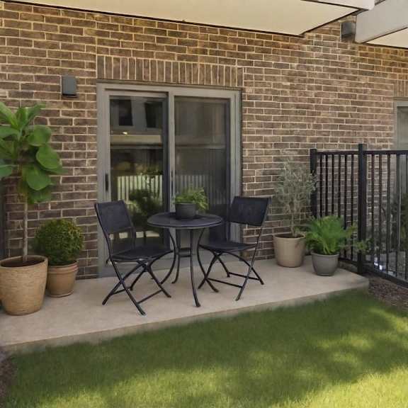 Patio with folding chairs and potted plants at Arden at Corinth Apartments, Texas