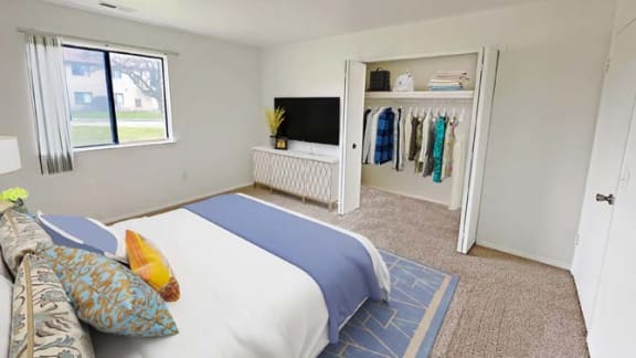 a bedroom with a bed and a tv in it