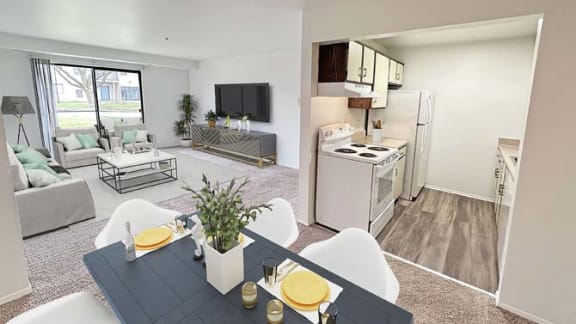 a living room and kitchen with a table and chairs
