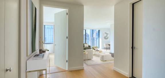 A white door is open to a living room.