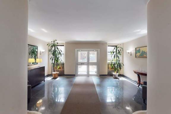 A spacious room with a large mirror on the wall.