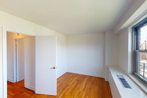 A room with a window and a door.