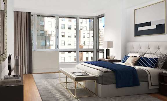 A modern bedroom with a large bed and a view of the city.