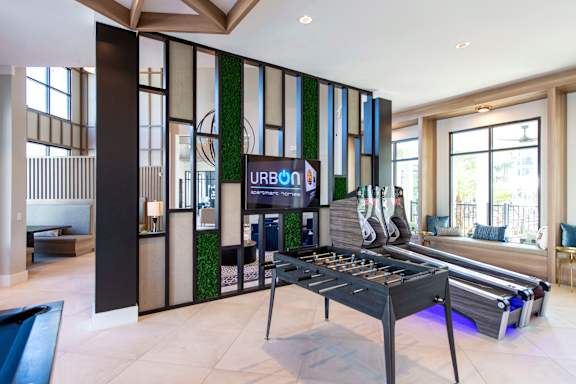 A billiard table in a room with a sign that says "URBAN".