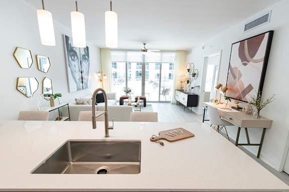 A modern kitchen with a large sink and a countertop.