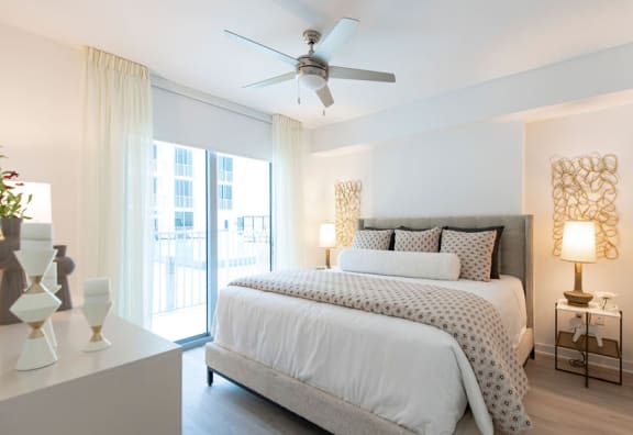 a bedroom with a large bed and a ceiling fan