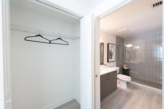 A bathroom with a toilet, sink, and a glass shower stall.