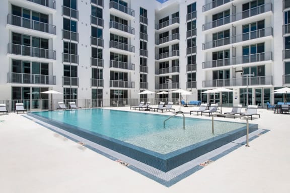 a swimming pool in front of an apartment building