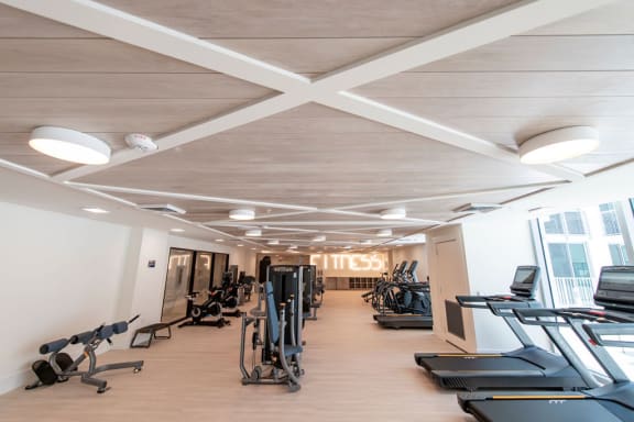 a gym with treadmills and other exercise equipment