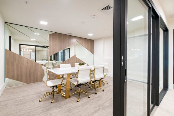 a conference room with a white table and chairs