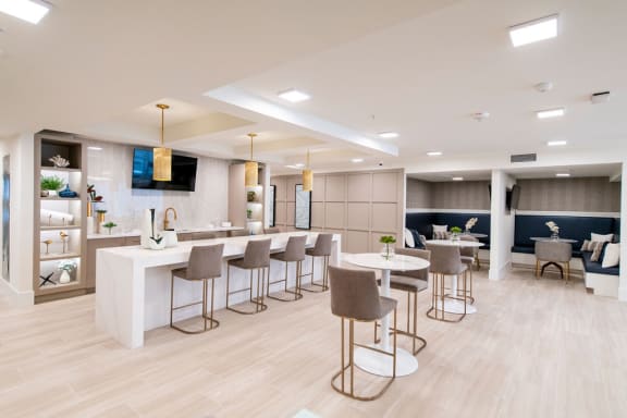 a communal area with tables and chairs in a lobby